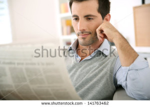 stock-photo-man-at-home-reading-newspaper-141763462